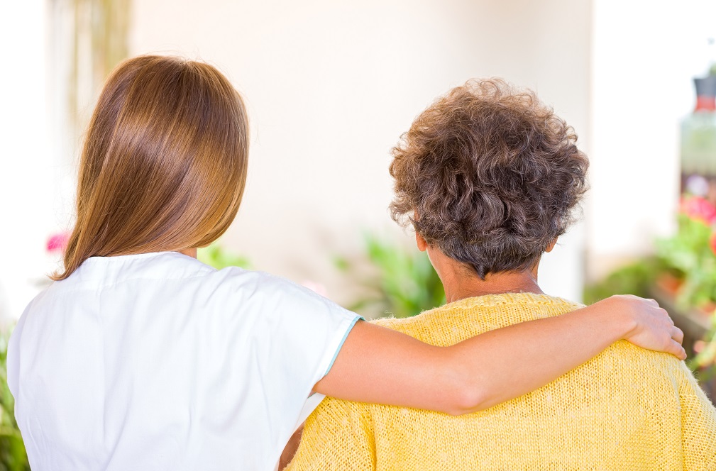 Photo of elderly woman with her caregiver