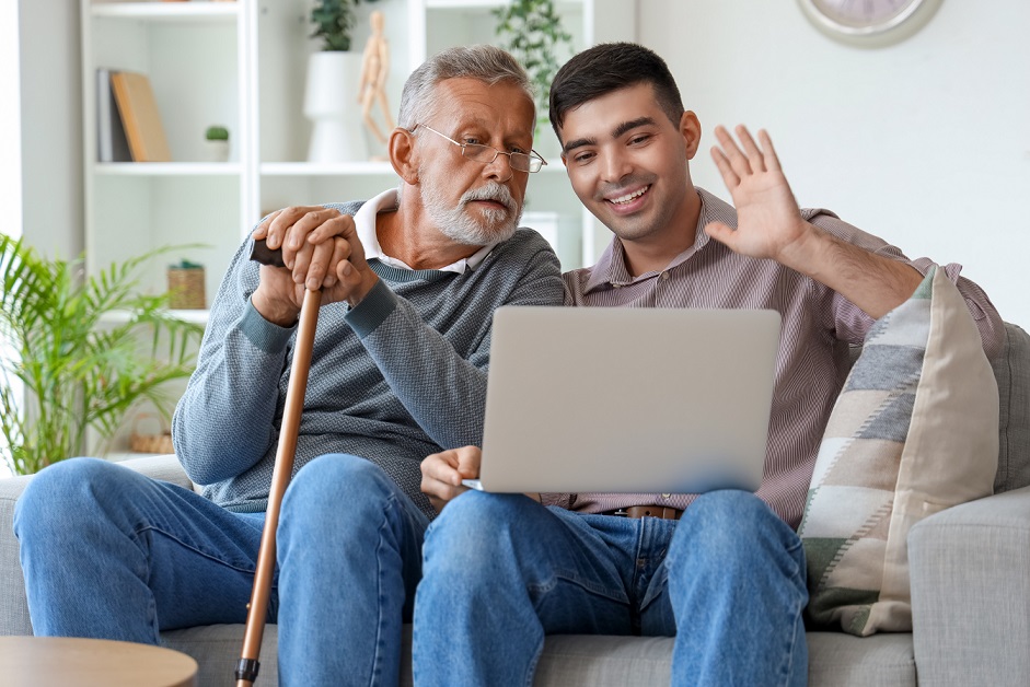 Senior man with his son video chatting at home